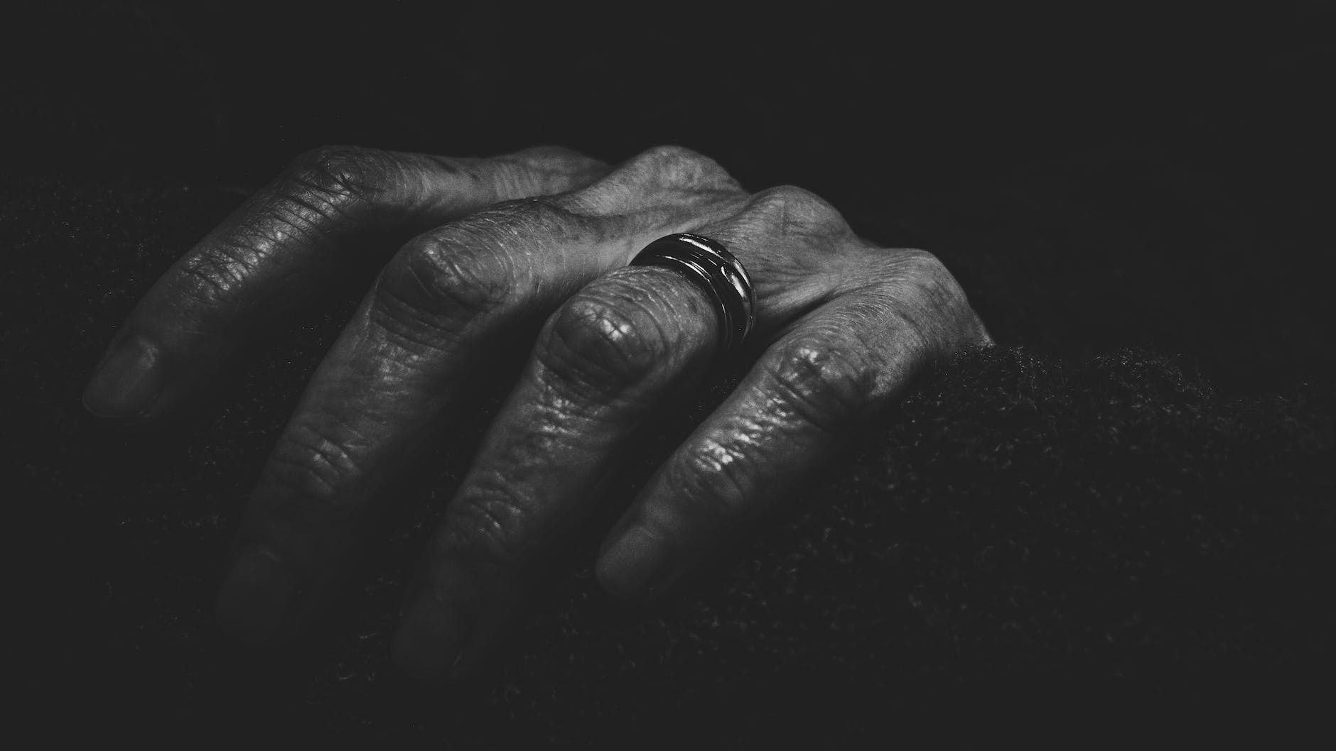 close up photography of a hand with ring